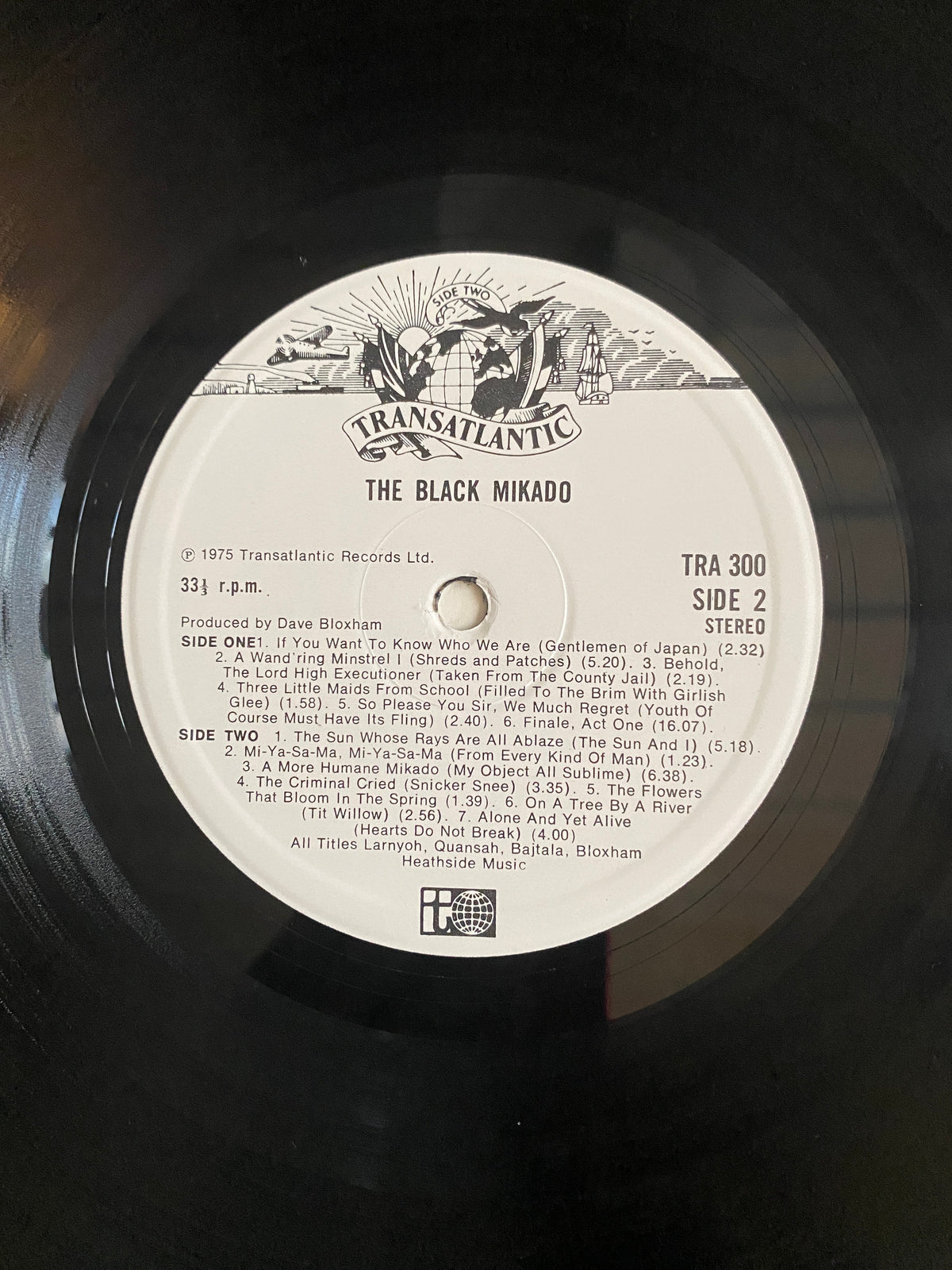 Black vinyl record with white center label and transatlantic records logo for Various Artists The Black Mikado LP