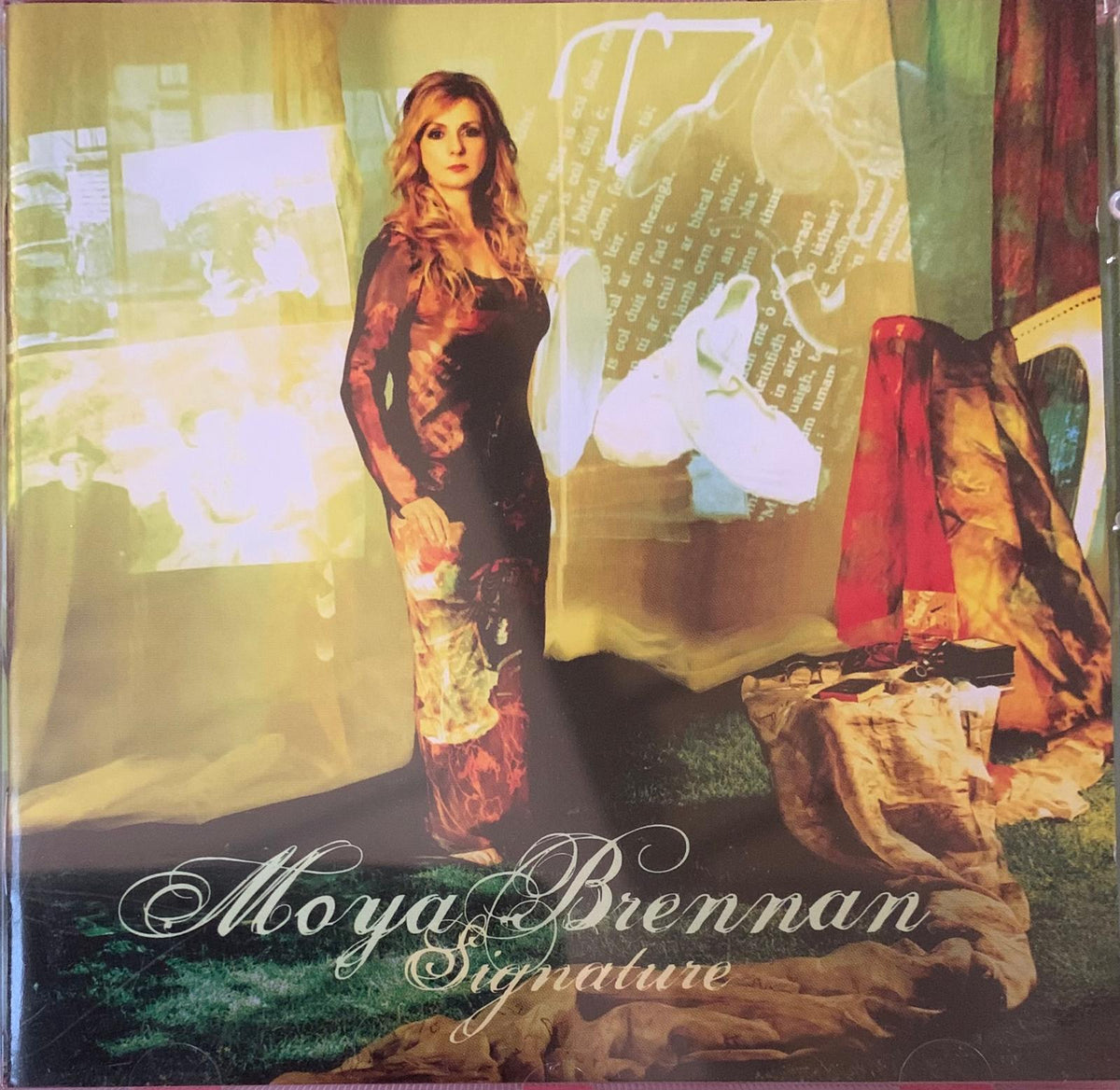 Moya Brennan signature CD album cover featuring a woman in an elegant dark patterned gown with floral accents