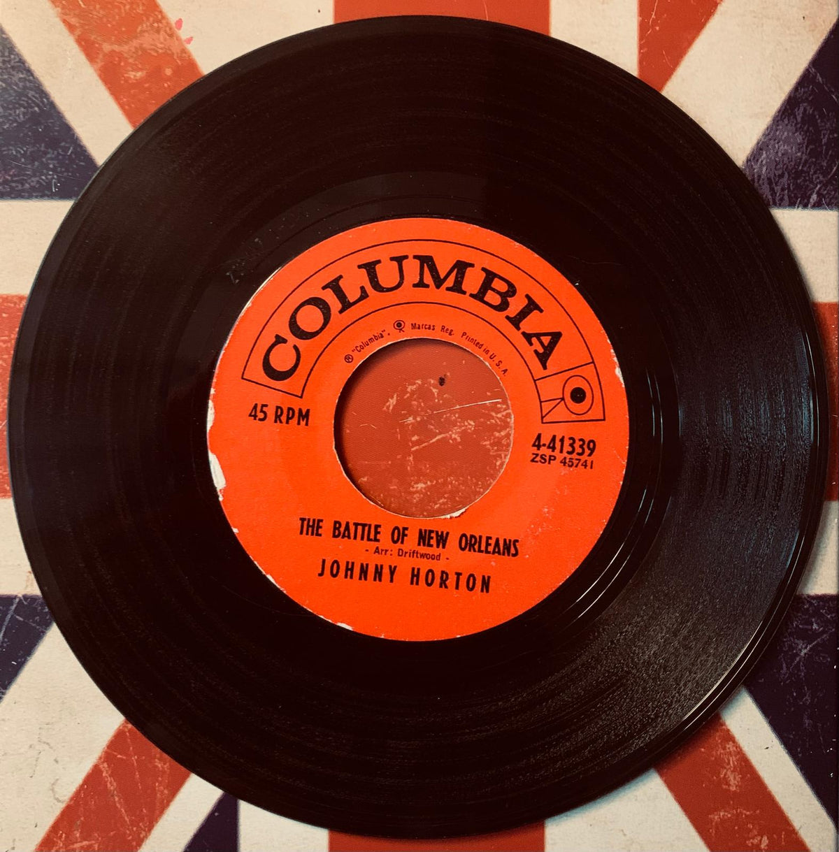Black vinyl record with vibrant orange columbia label featuring the battle of new orleans by johnny horton on original 45t vinyl