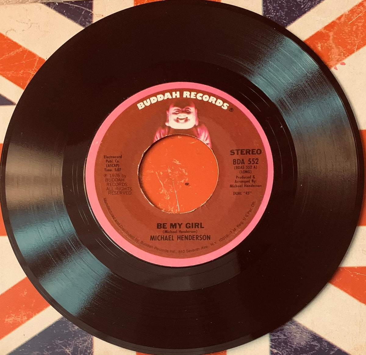 Black vinyl record with pink and orange buddha records label featuring michael henderson be my girl song title