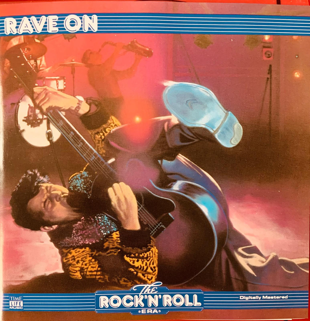 The album cover of Various Artists the rock n roll era rave on CD features a guitarist with red and blue lighting