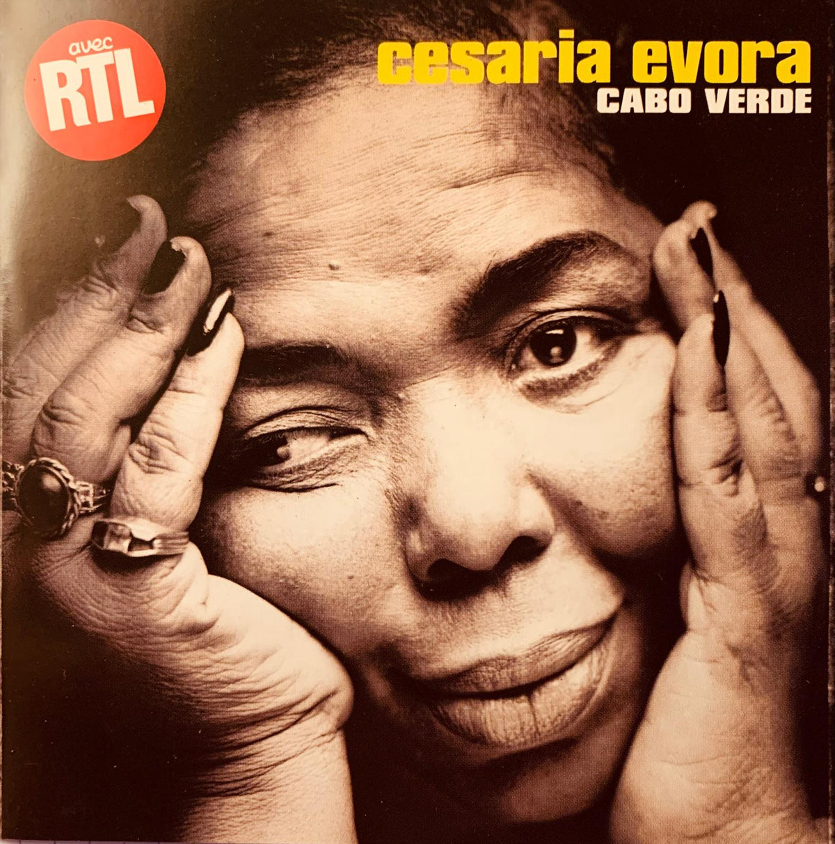 Sepia-toned album cover of cesária évora cabo verde original cd featuring african singer in vintage style