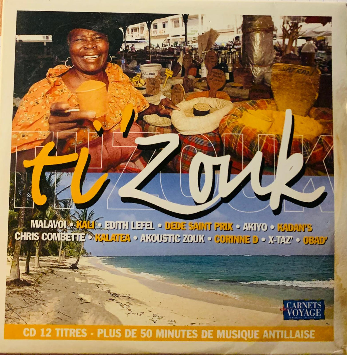 The album cover of various artists ti’zouk original cd shows a smiling woman in an orange dress holding a yellow cup on a beach