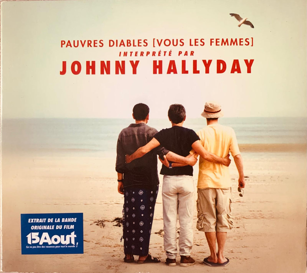 Album cover of pauvres diablos vous les femmes by johnny hallyday showing three men on a beach with arms around each other