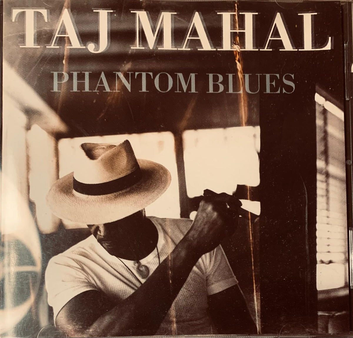 Taj Mahal phantom blues original 1996 CD cover with sepia photo of artist wearing light straw fedora with dark band