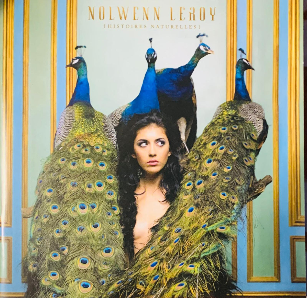 Album cover of Nolwenn Leroy Histoires Naturelles 2010 original CD featuring a woman surrounded by four blue and green peacocks