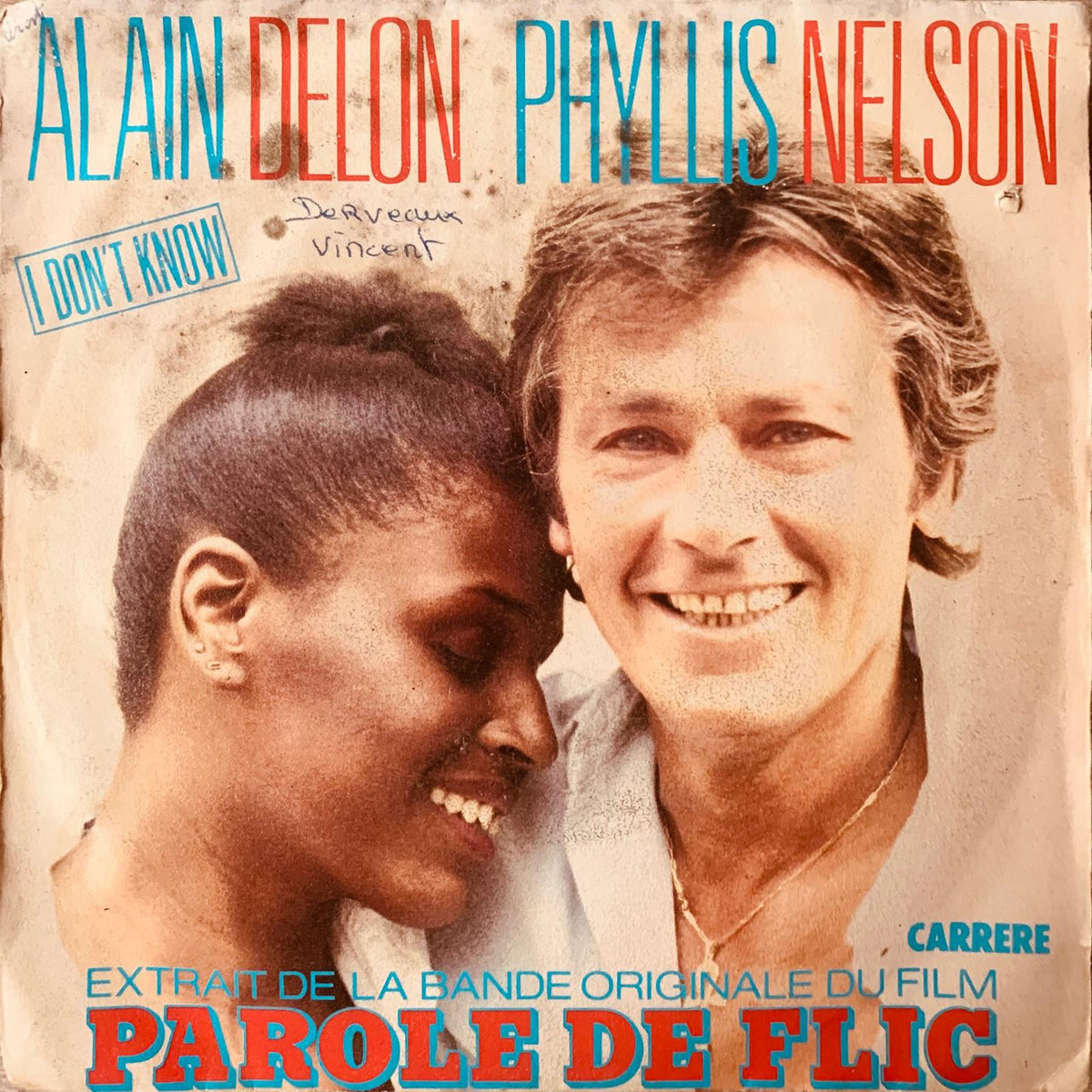 Vintage french vinyl record sleeve of alain delon and phyllis nelson with faded sepia tones and red blue typography