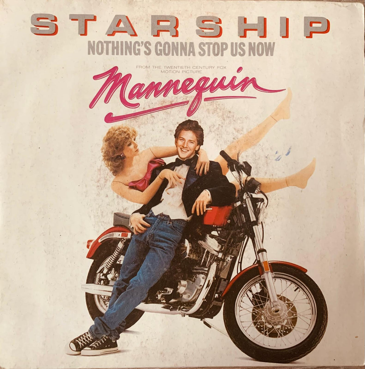 Red and black chrome motorcycle with man in jeans and bow tie featured in Starship Nothing’s Gonna Stop Us Now vinyl record