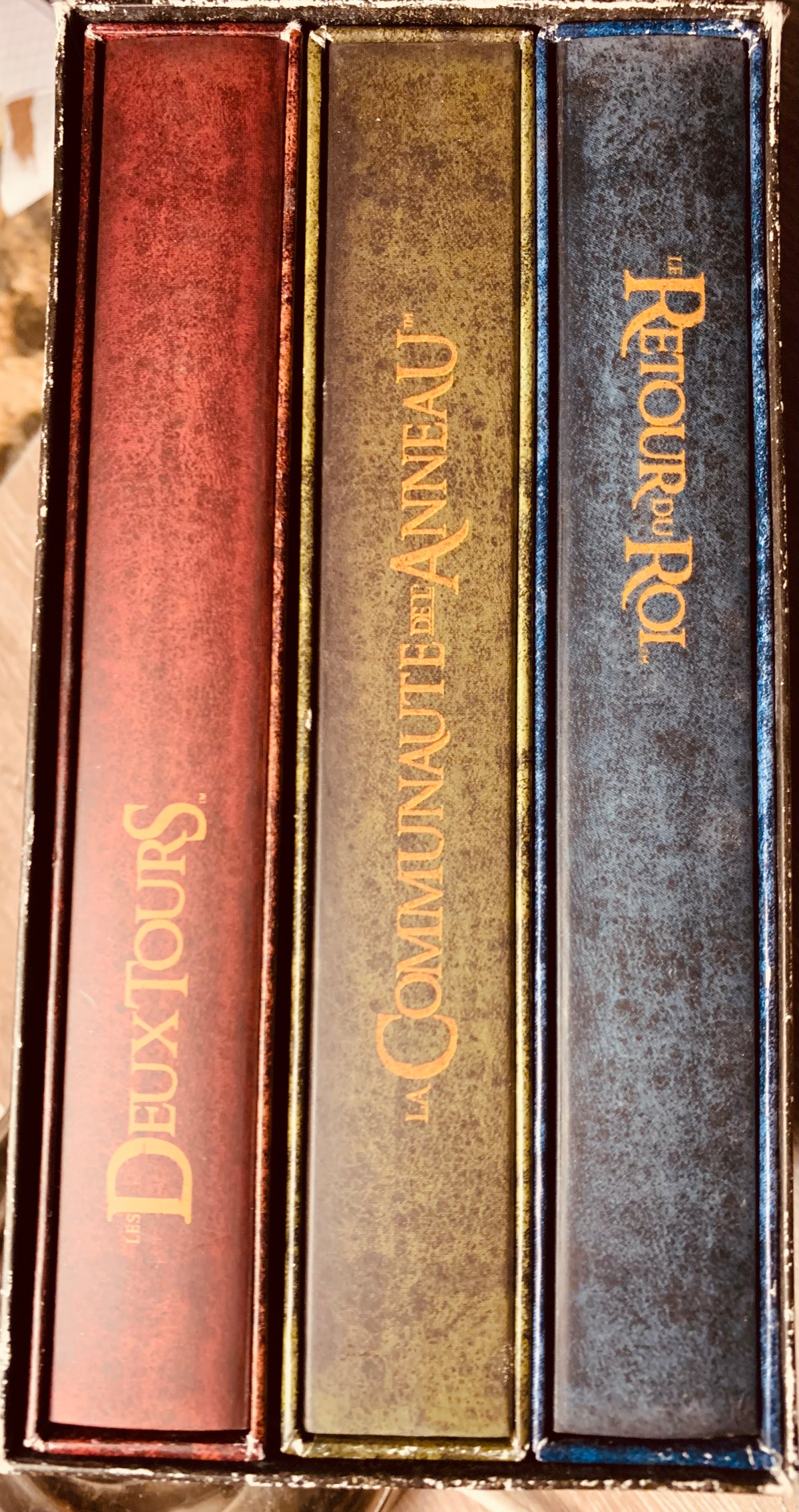 Three hardcover books in set cd 001 with textured covers and gold lettering in red green and blue colors