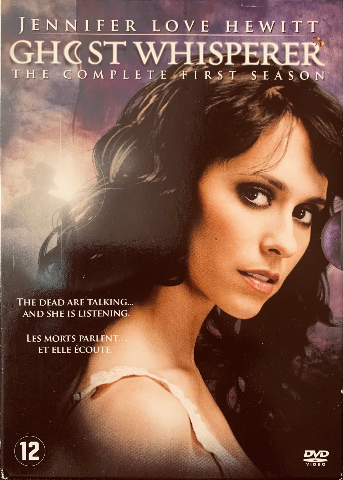 The dvd cover for ghost whisperer the complete first season features jennifer love hewitt in a dark moody portrait