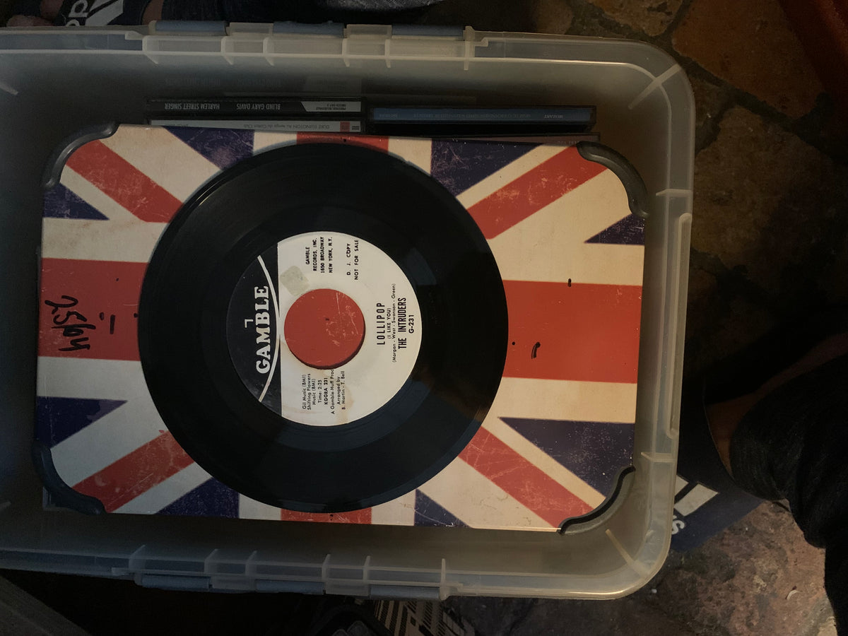Black vinyl record with white label featuring red and black text on union jack surface in clear plastic case for soul 7