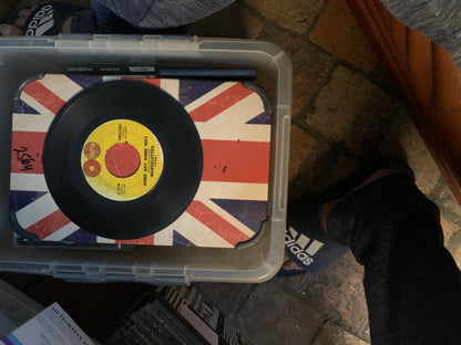 Black vinyl record with yellow label featuring red and black text on union jack surface in clear plastic container for soul 7