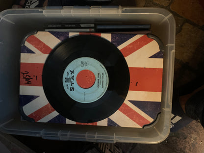 A black vinyl soul 7 inch record with a light blue and orange stax records center label