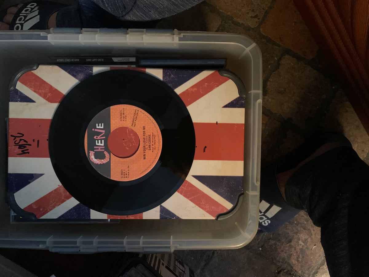 Black vinyl record with orange label featuring cher and song title resting on union jack surface for soul 7 product