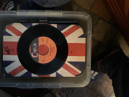 Black vinyl record with orange label featuring cher and song title resting on union jack surface for soul 7 product
