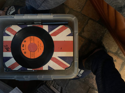 Soul 7 black vinyl record with orange sims records label on union jack surface inside clear storage bin
