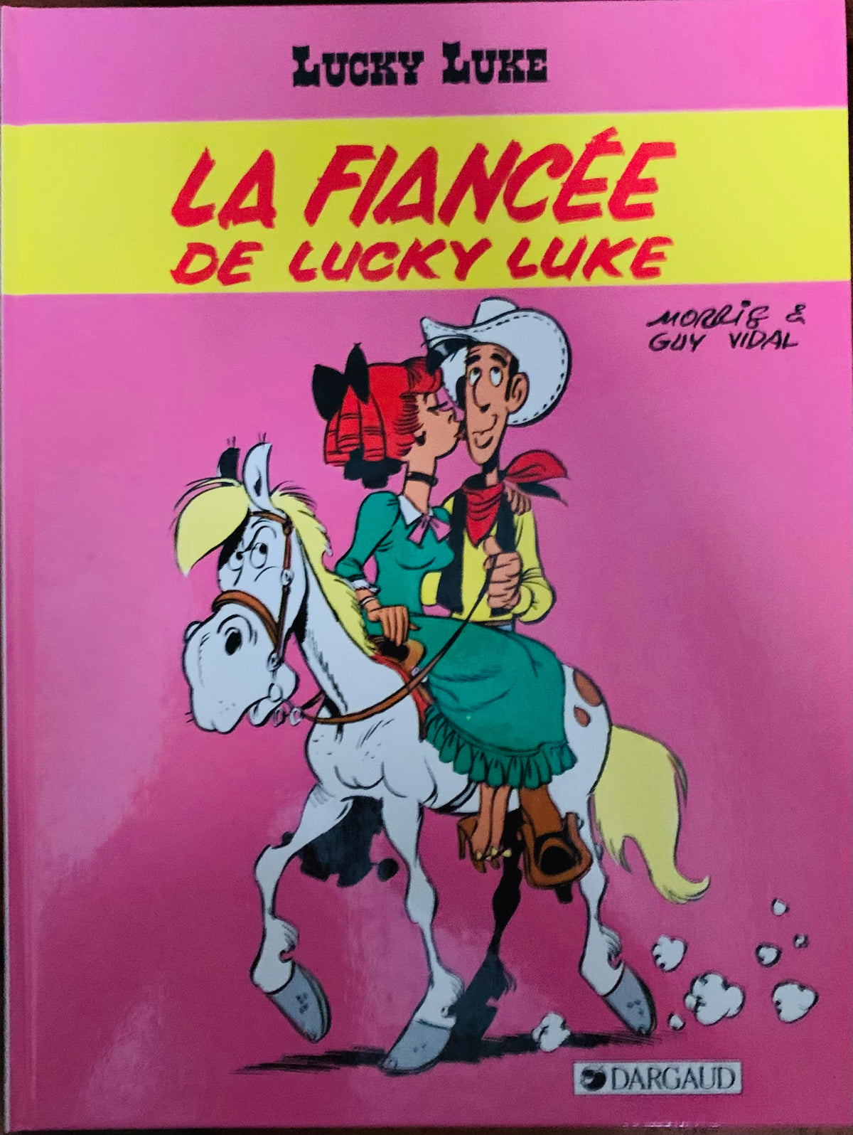 Pink comic book cover of lucky luke and fiancée riding a white horse with yellow mane in classic cartoon style bd mix