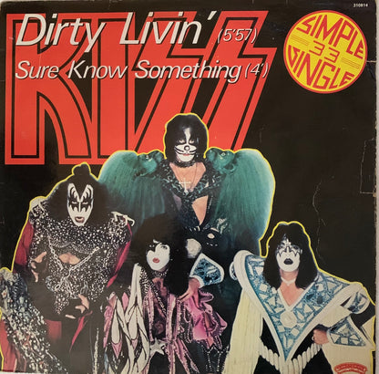 Black vinyl record sleeve for kiss 1976 single dirty livin featuring band members in makeup with red logo backdrop