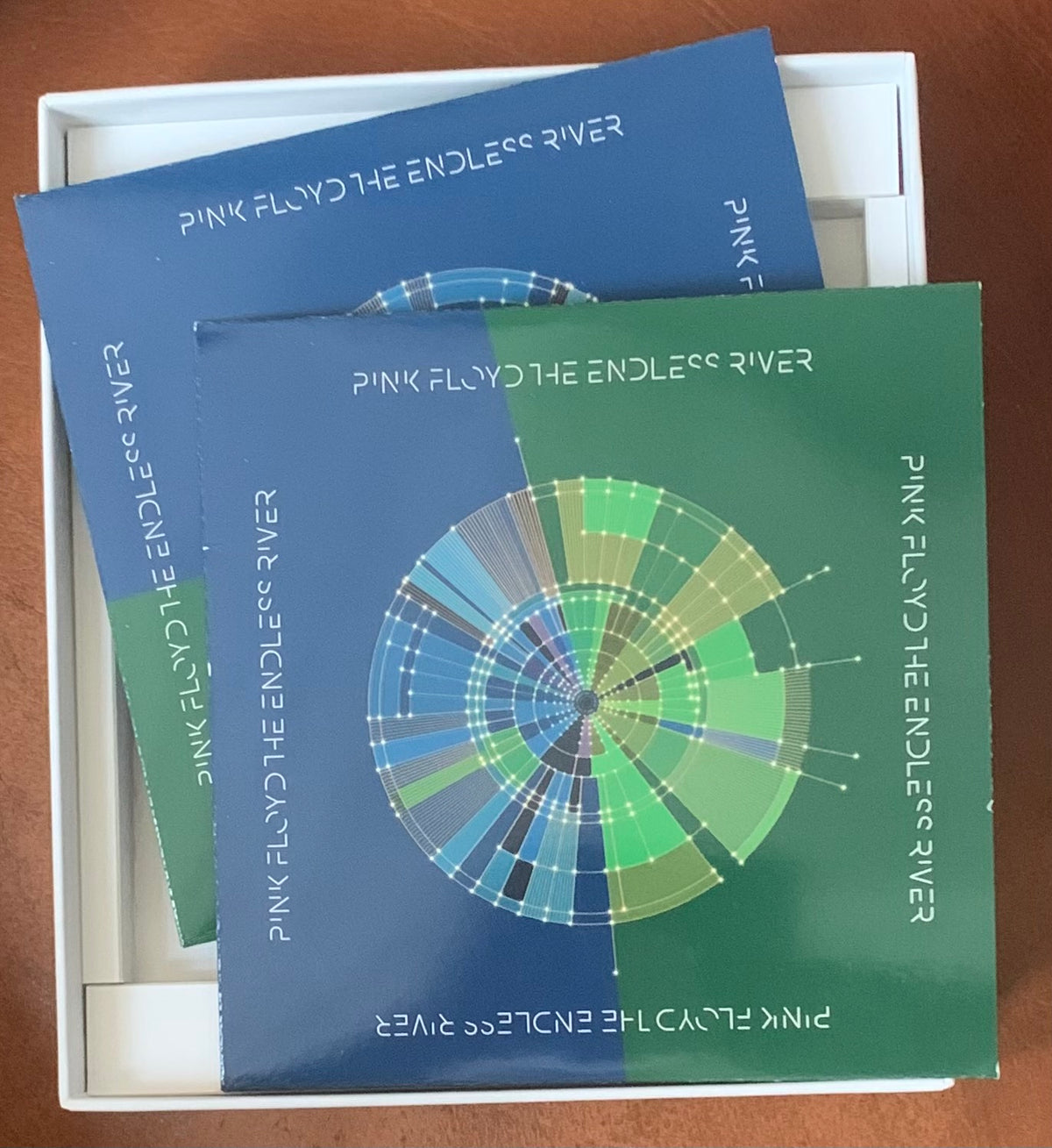 Blue and green album cover for Pink Floyd The Endless River featuring a circular radial design with concentric rings