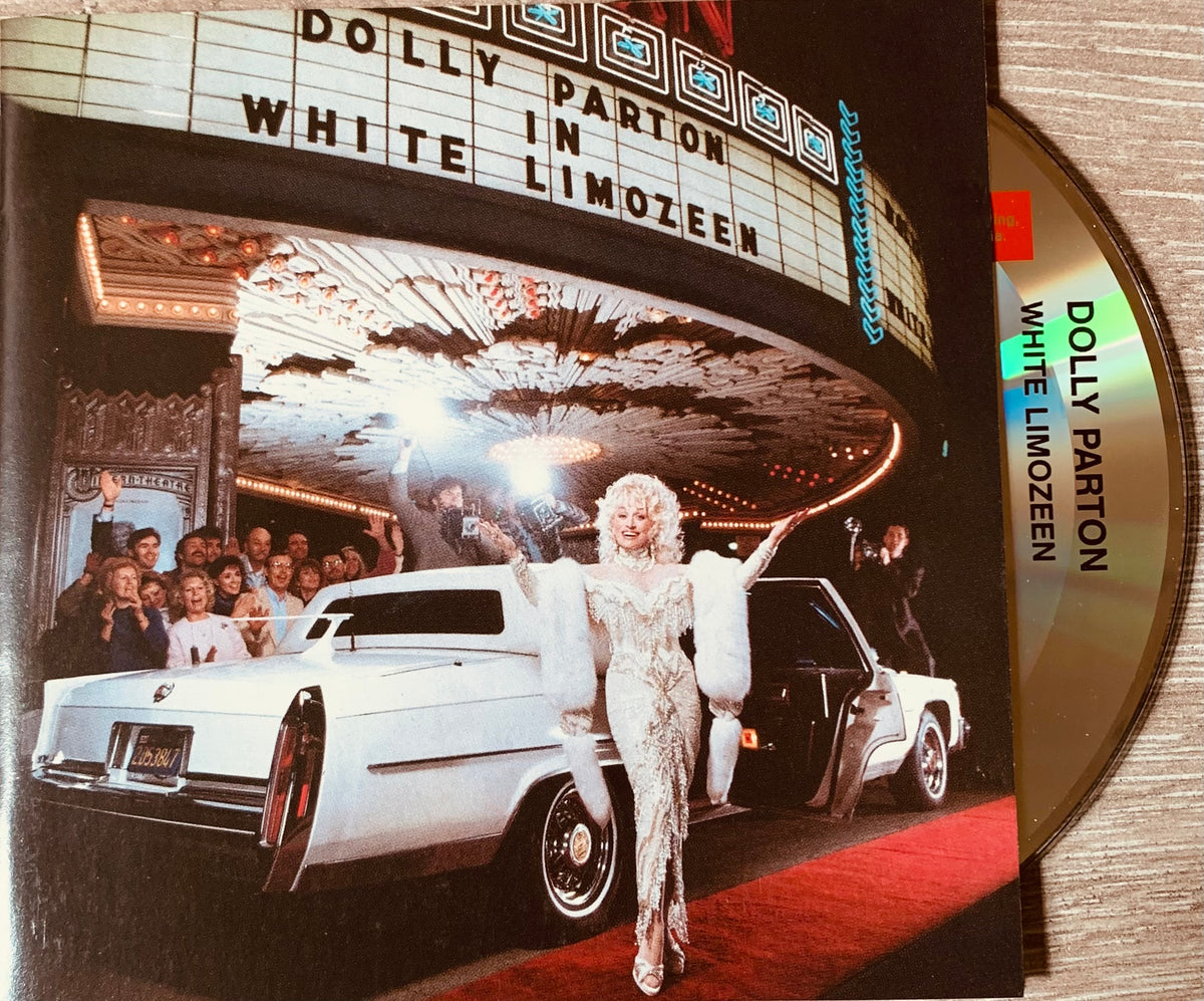 The cd album cover for dolly partons white limozeen shows a glamorous white cadillac under an ornate theater marquee