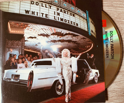 The cd album cover for dolly partons white limozeen shows a glamorous white cadillac under an ornate theater marquee