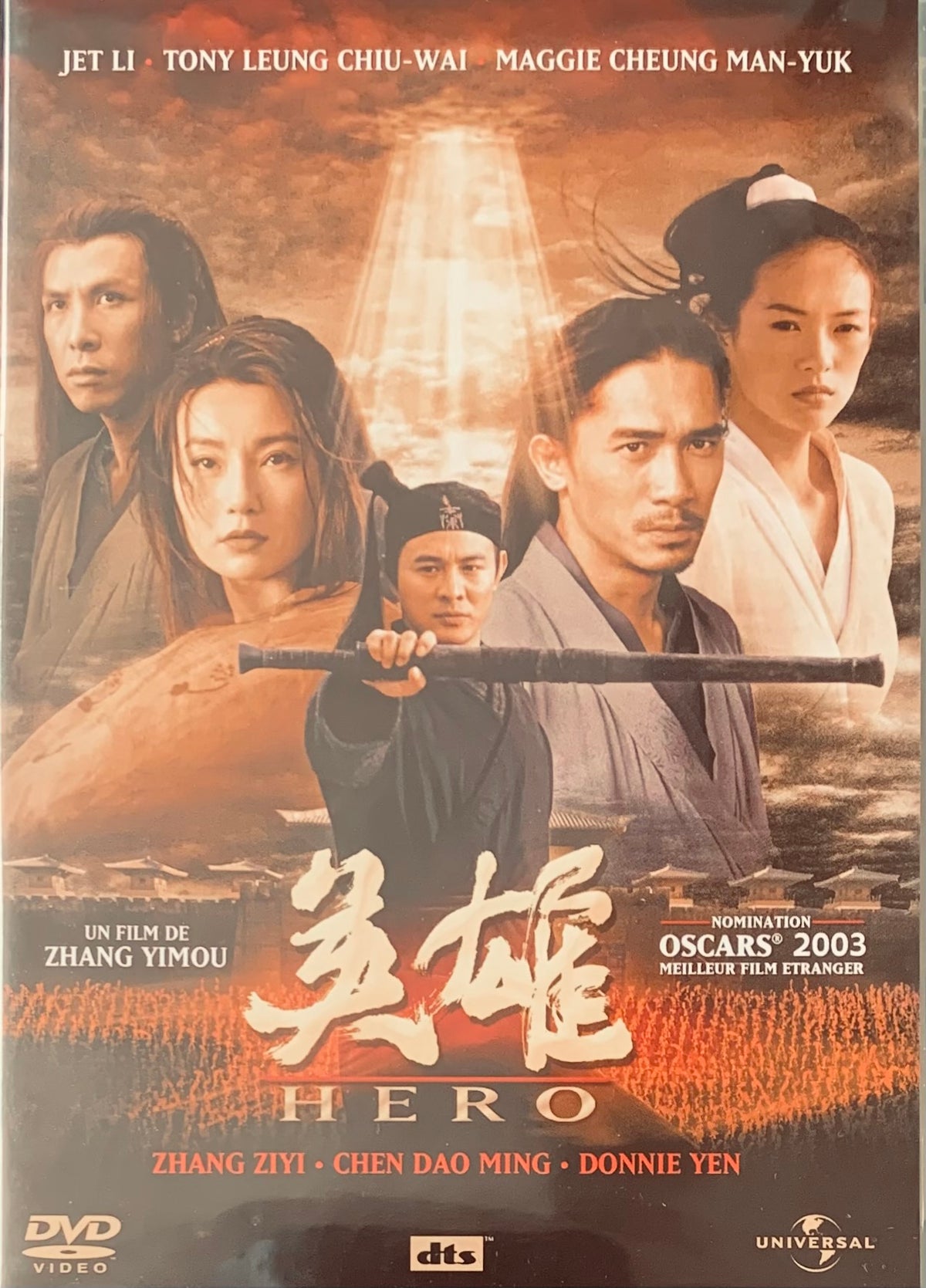 The dvd cover for the 2003 film Hero features donnie yen with a black staff and other cast against an orange backdrop