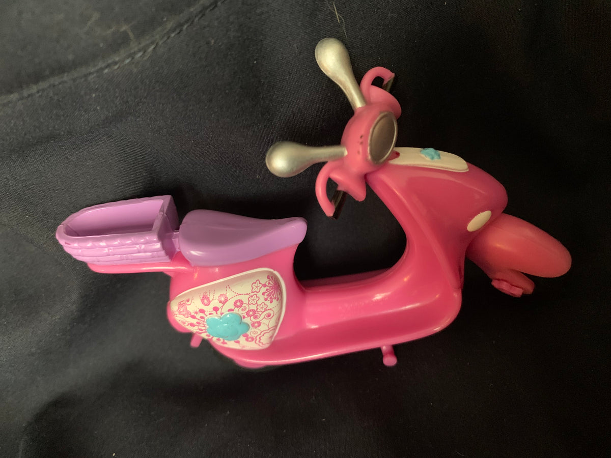 Pink plastic scooter toy with purple seat gold handlebars and decorative floral panel from Toys 001 collection