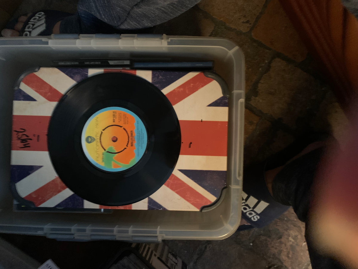 Black vinyl record with colorful label resting on union jack surface for soul 7 inch music collection