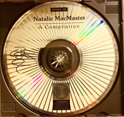 A signed compact disc with beige and silver sunburst design titled natalie macmaster a compilation by greentrax records