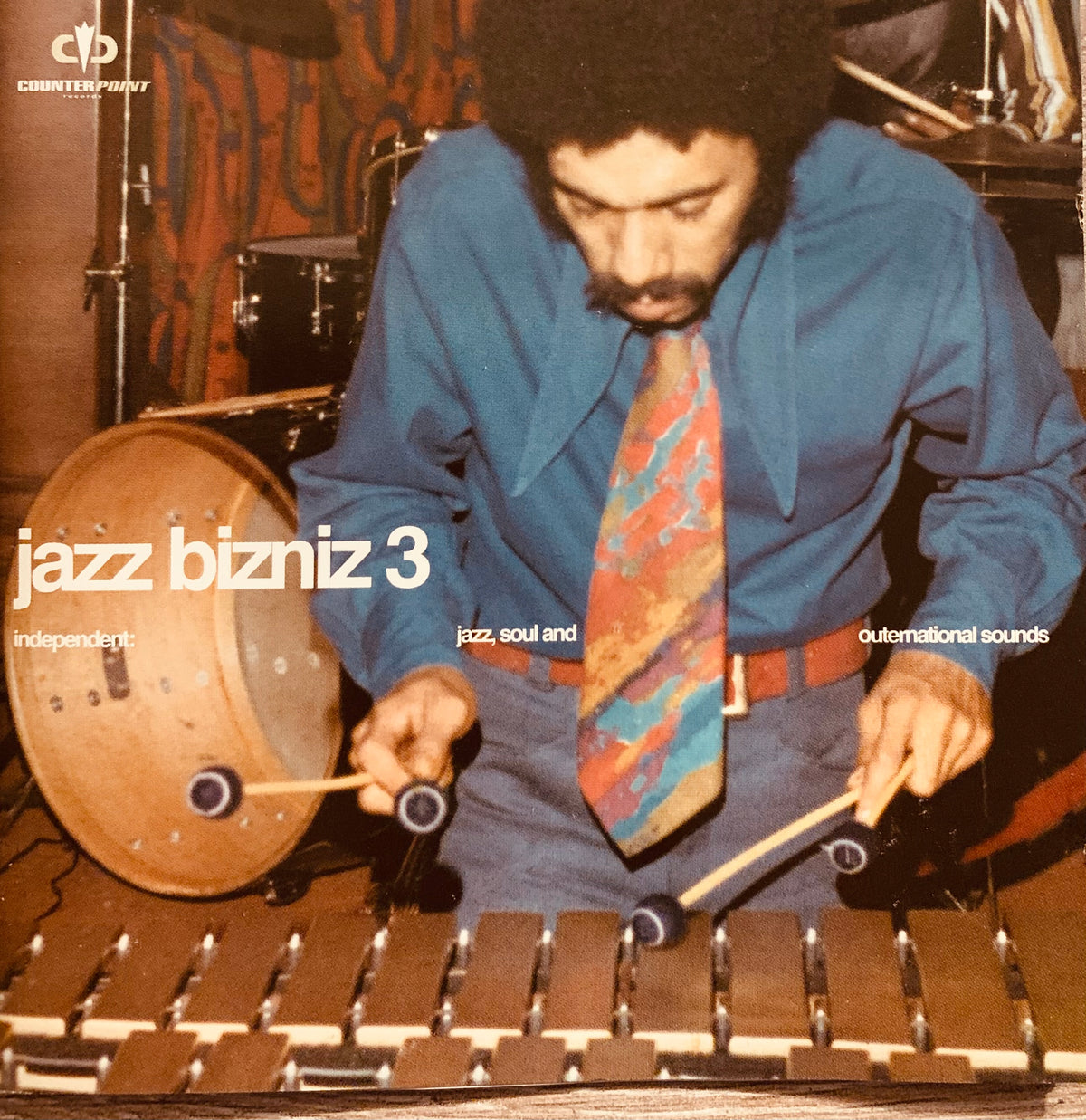 Vintage jazz album cover cd 001 featuring a man in a blue shirt playing a wooden marimba with drumsticks