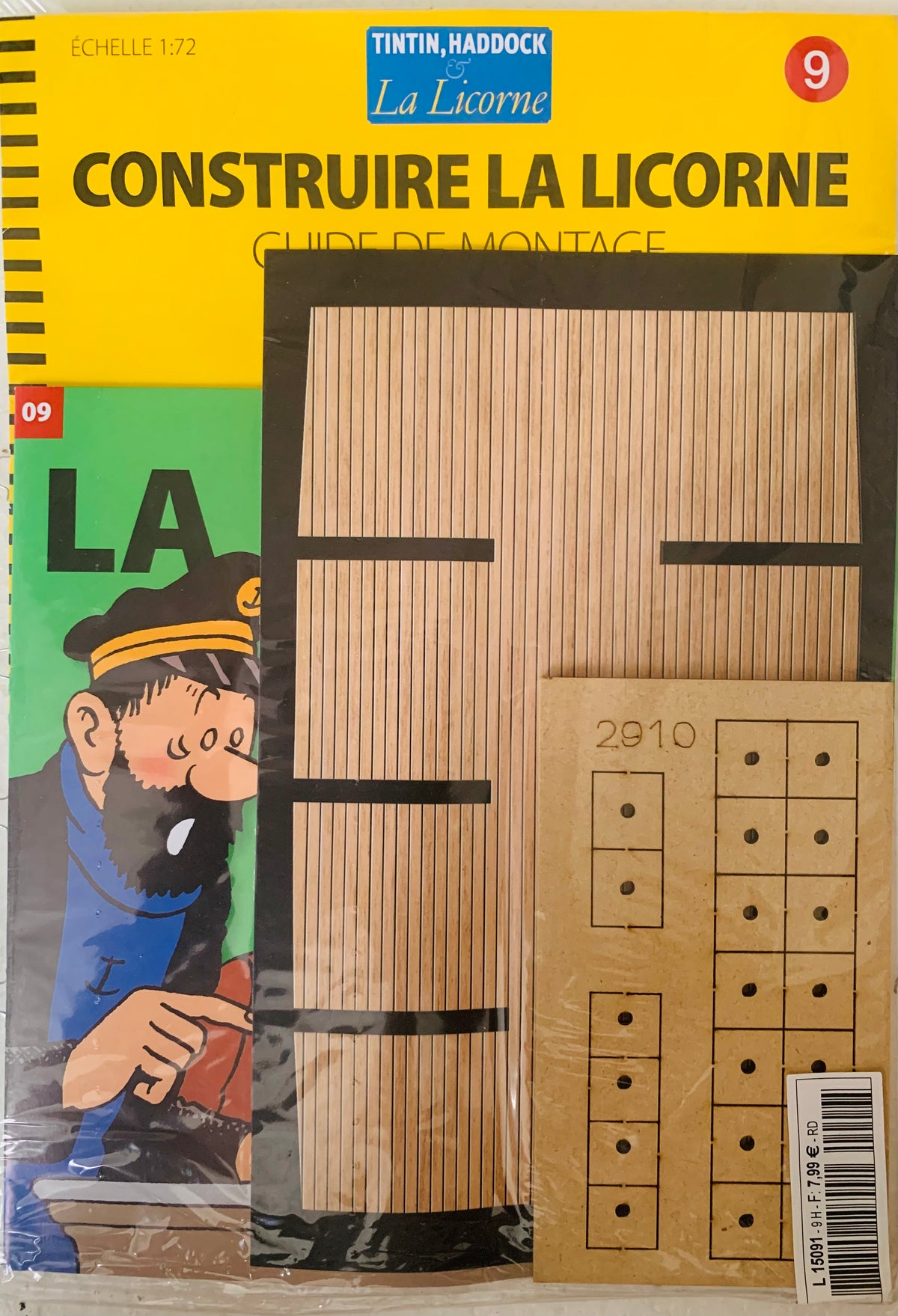 Yellow and green tintin and haddock la licorne model kit packaging with illustrated characters and wooden construction pieces