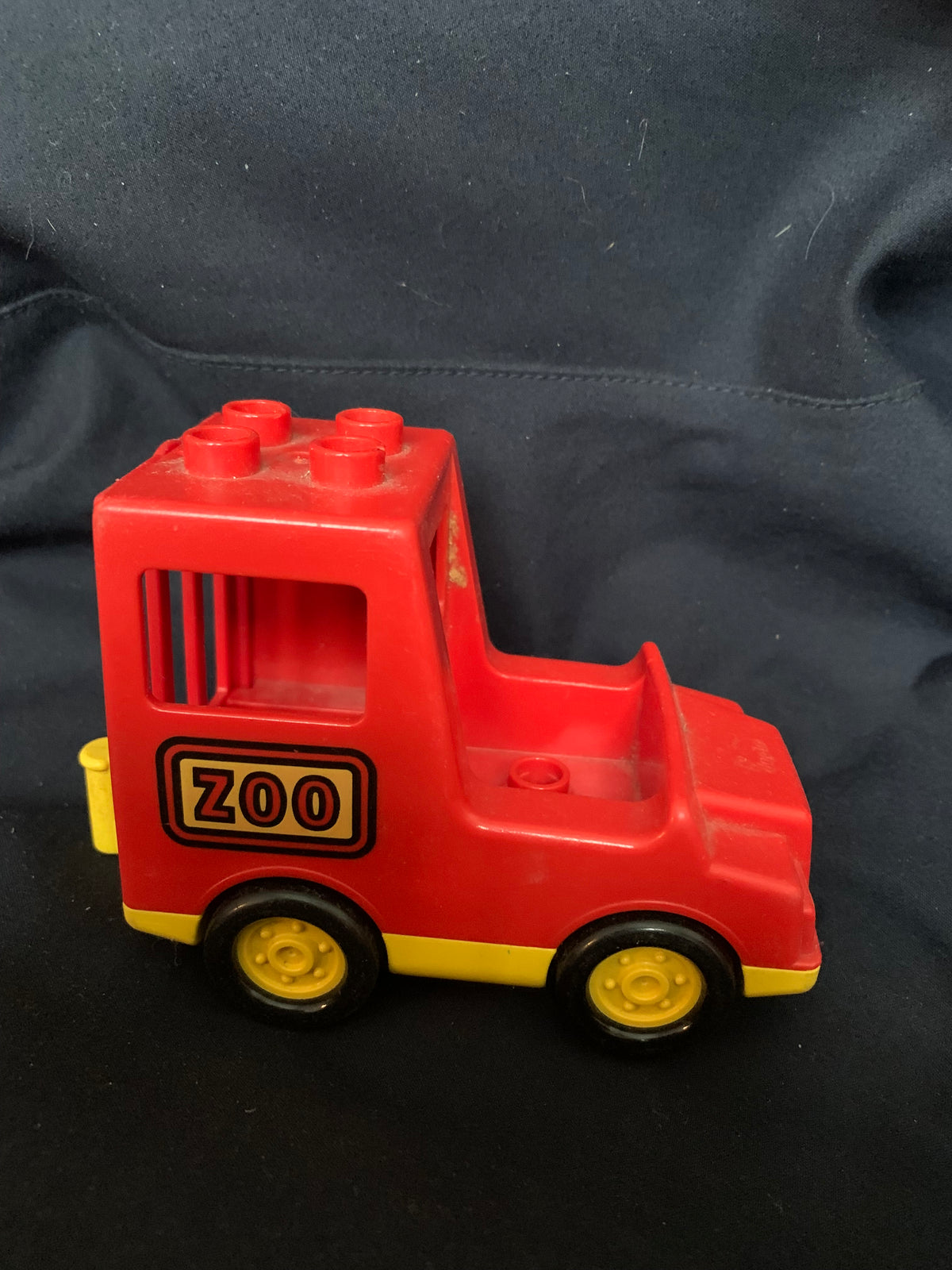 Red and yellow plastic toy truck labeled zoo designed for building blocks in toys 001 product line
