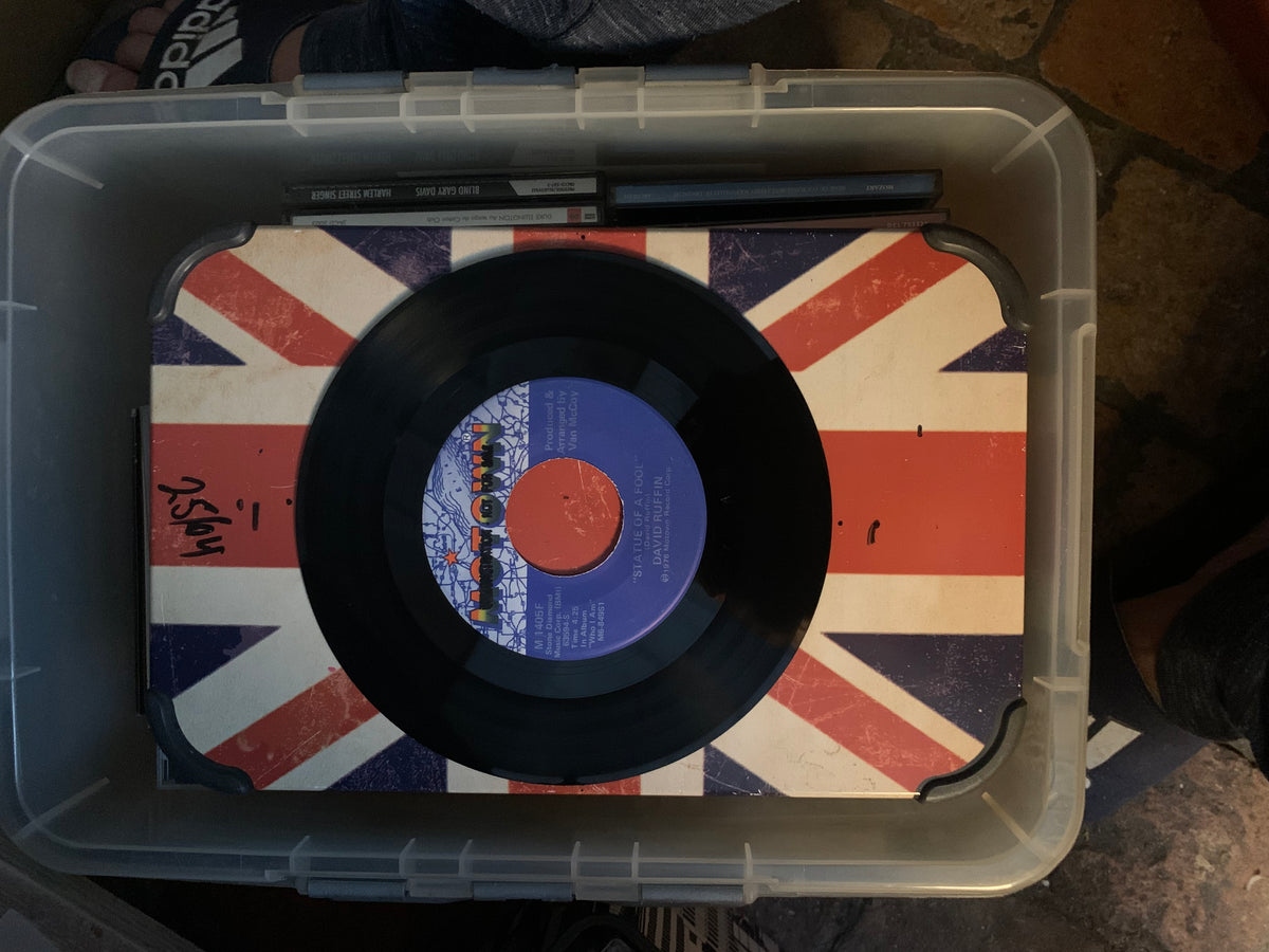 Black vinyl soul 7 inch record with blue and orange label on union jack surface for music collection