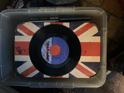 Black vinyl soul 7 inch record with blue and orange label on union jack surface for music collection