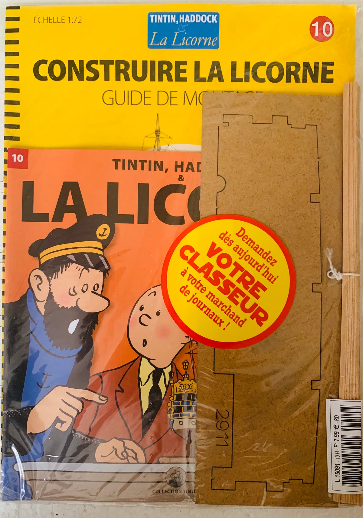Yellow and orange illustrated La Licorne booklet featuring Tintin captain Haddock and a cardboard lighthouse model kit