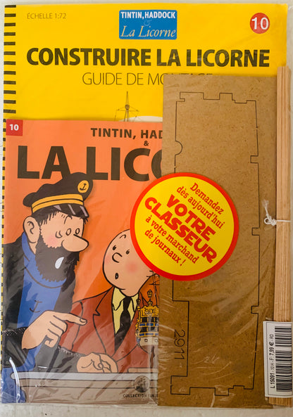 Yellow and orange illustrated La Licorne booklet featuring Tintin captain Haddock and a cardboard lighthouse model kit
