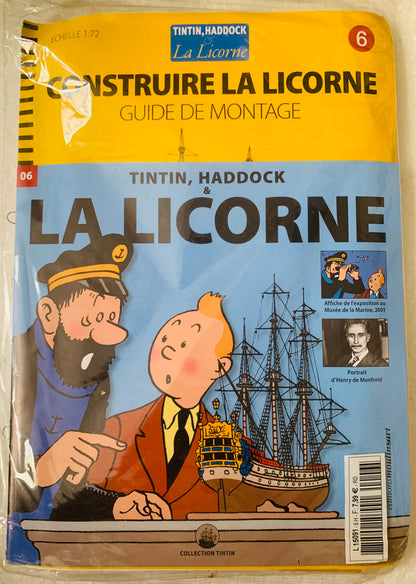 Yellow and blue illustrated booklet featuring tintin and captain haddock with detailed model ship construire la licorne