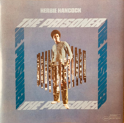 Herbie hancock the prisoner vinyl album cover showing a man with afro behind cassette tape bars on blue background cd 001