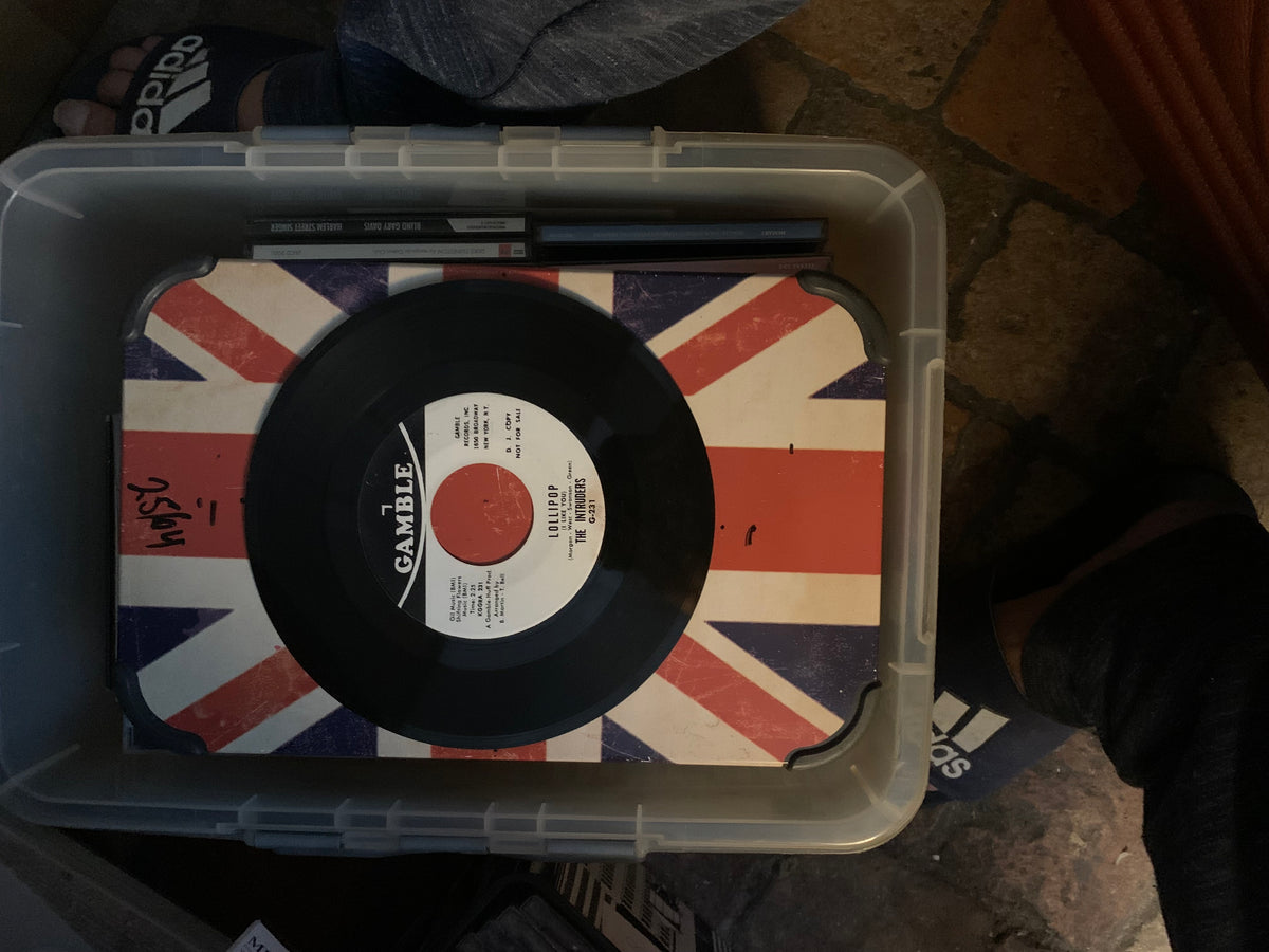 Black vinyl record soul 7 with white label and red center featuring gamble logo on union jack surface in clear container