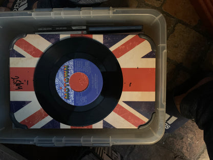 Black vinyl soul 7 record with blue and orange motown label resting on a union jack surface