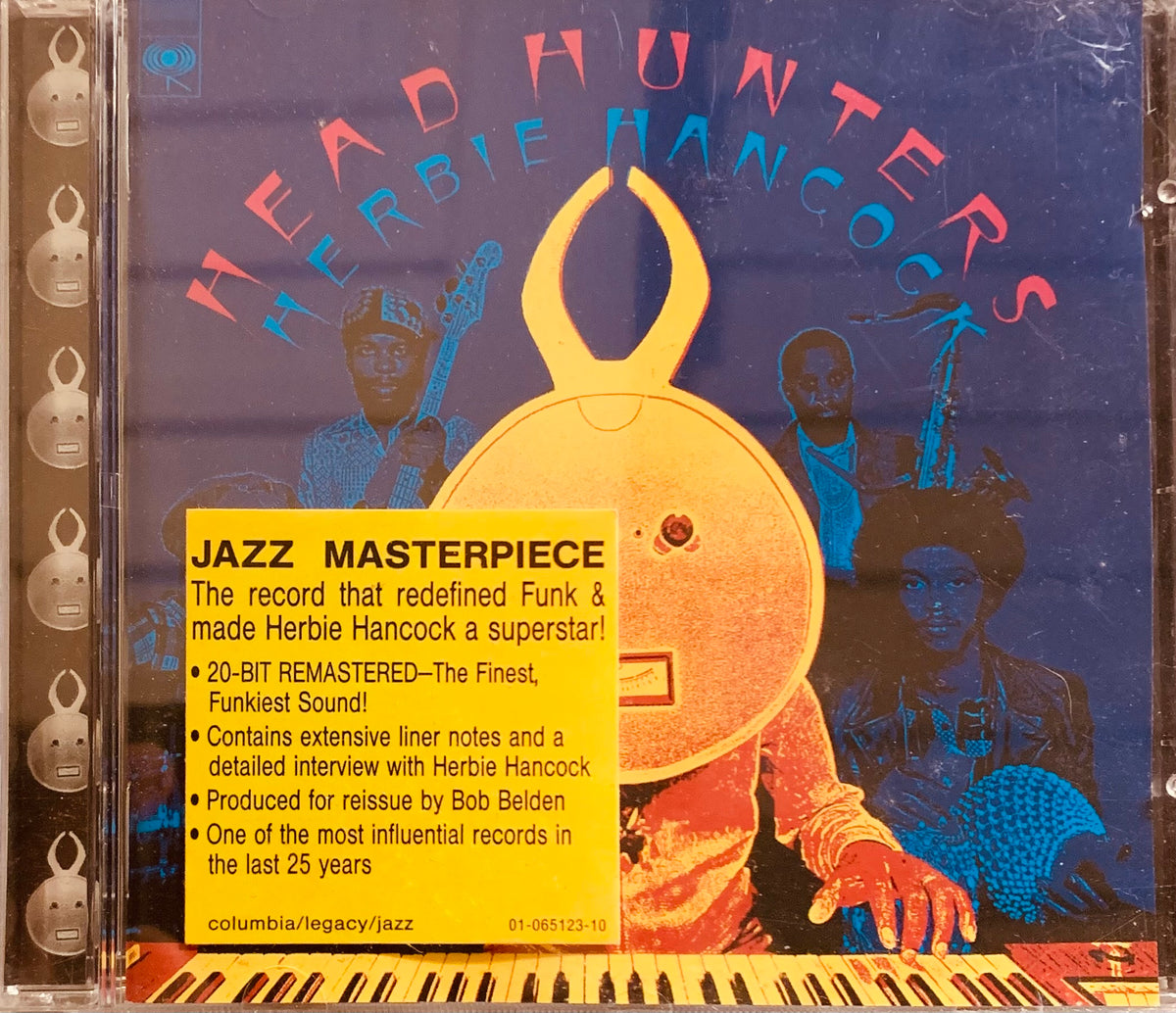 Yellow cd jewel case featuring herbie hancock headhunters album with golden rabbit head and blue-toned musicians design