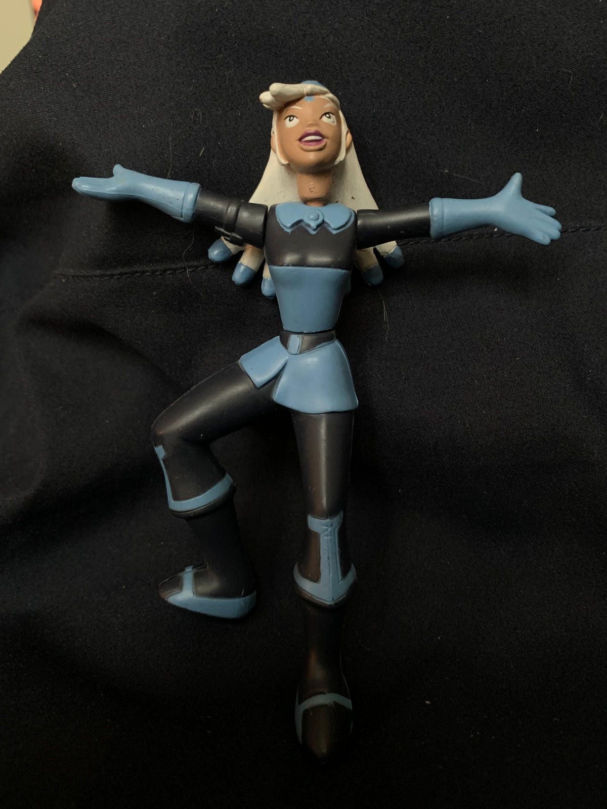 Blue and black plastic action figure toys 001 of a female character with blonde hair wearing a stylized outfit