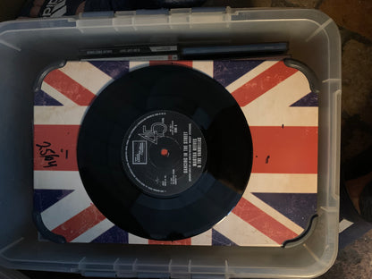 Soul 7 black 45 rpm vinyl record with white label and red center hole on union jack mat inside clear plastic bin