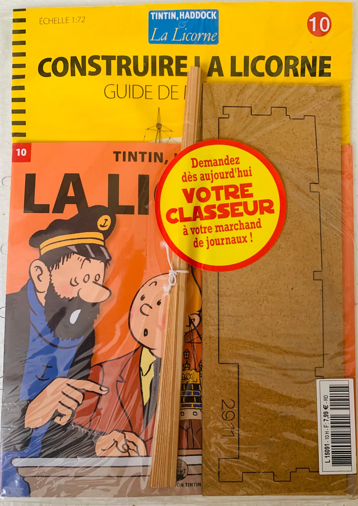 Yellow and orange tintin la licorne model kit with cardboard cutouts and wooden sticks for assembly