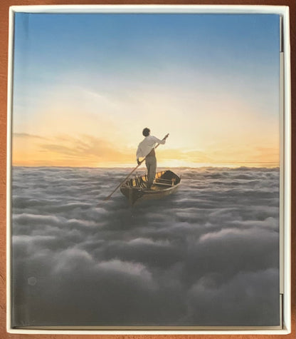 A serene illustration on a wooden rowboat with a man paddling through clouds at sunset in endless river