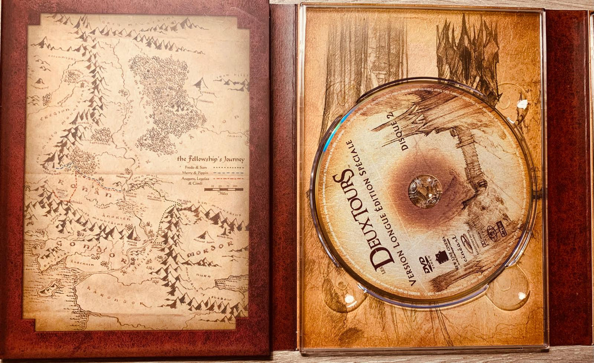 The fellowship’s journey map cd case with sepia shire and mordor illustration in the lord of the rings extended collector’s edition 4-dvd box set