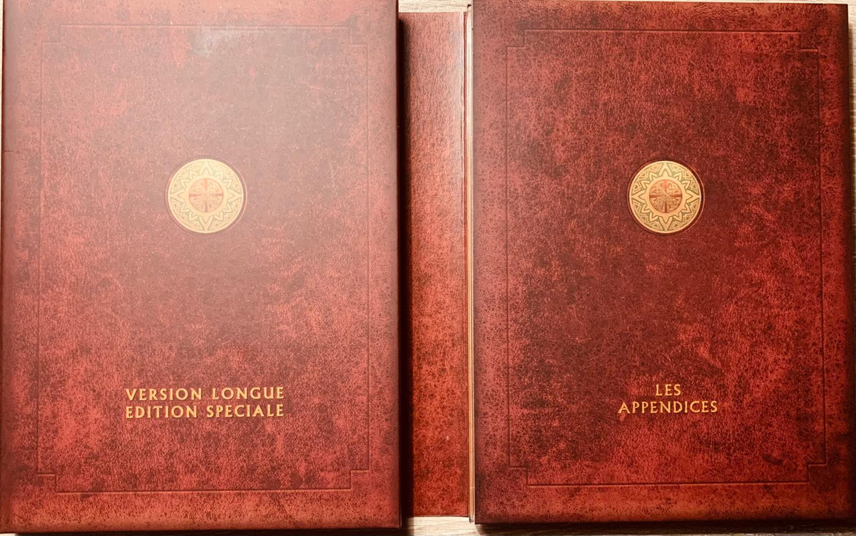 Two burgundy leather-bound books with gold embossed medallions from the lord of the rings return of the king extended collector’s edition 4 dvd box set