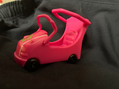 A bright pink plastic toy car with black wheels and a green logo on the hood from Toys 001