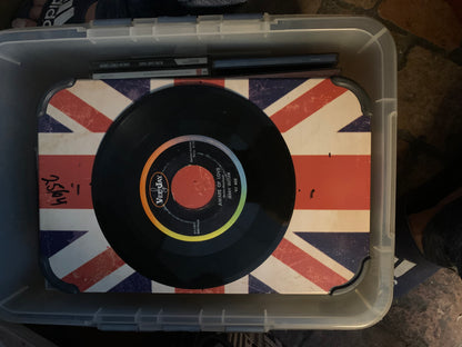 Black vinyl record with colorful verday label and song title on union jack surface from soul 7 product