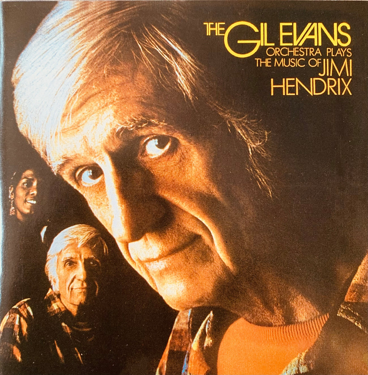 The gil evans orchestra vinyl album cover features a close-up portrait with warm golden lighting and shadows